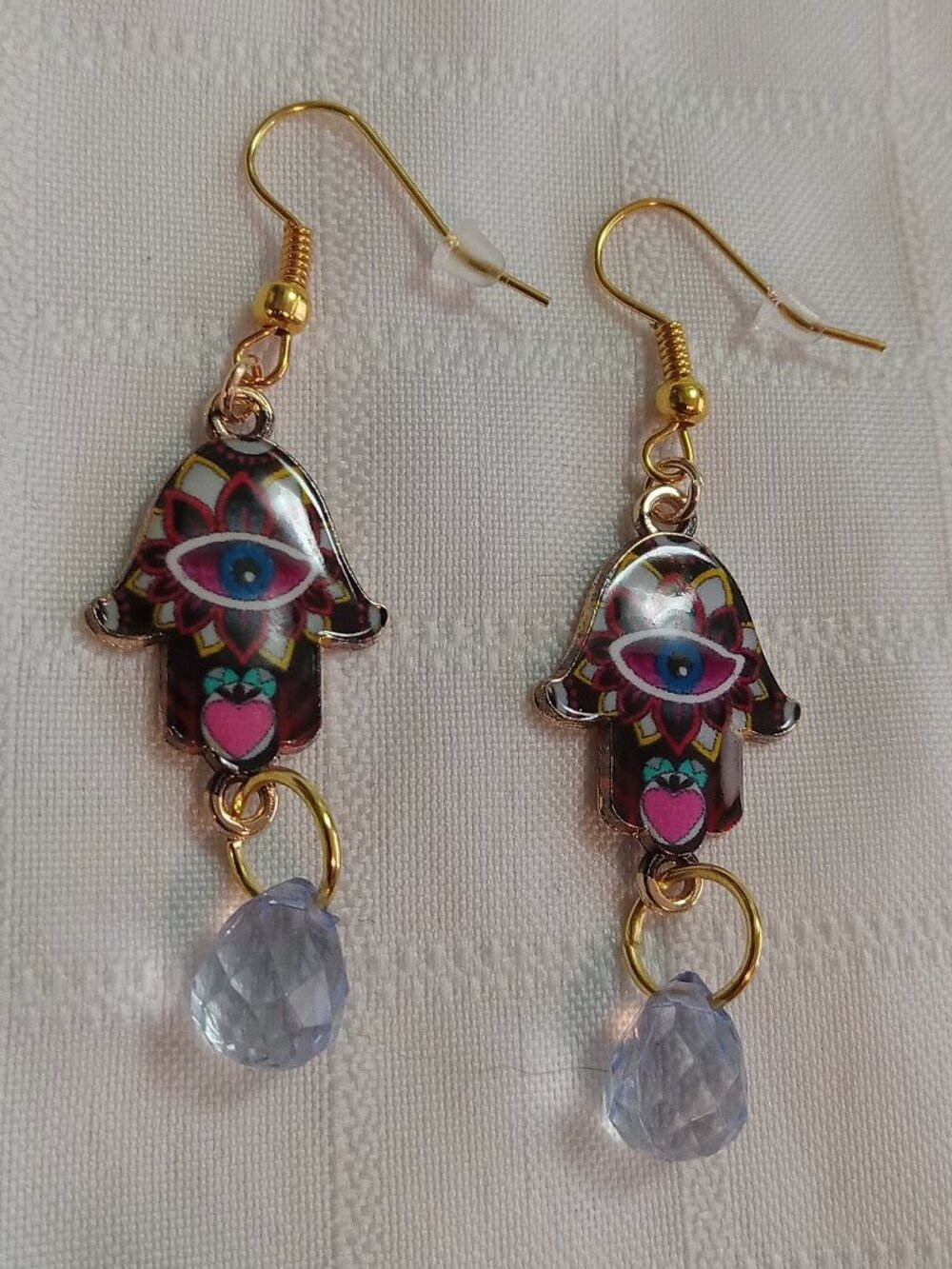 Handmade gold-colored earrings with multicolored enameled fatima hands and beads
